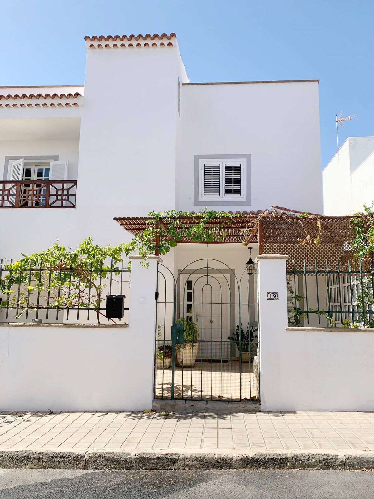 Tropical Sunset House — white Canarian villa with pergola and garden gate